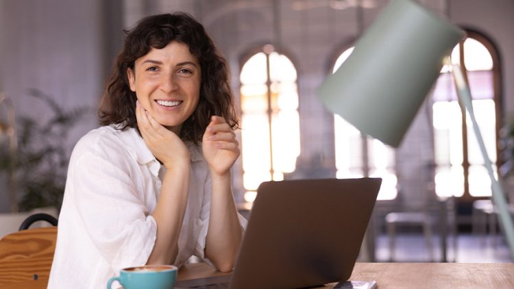 Une femme assise à son bureau devant son ordinateur