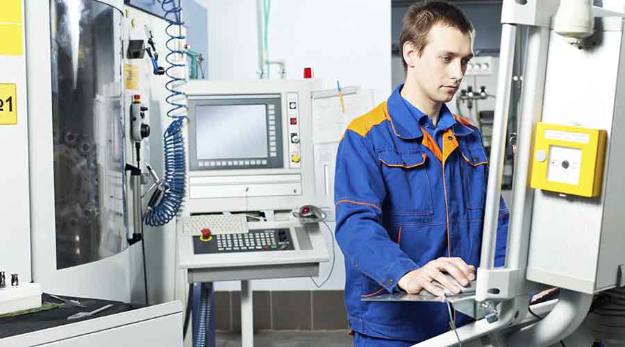 Technicien travaillant sur machine outil numérique