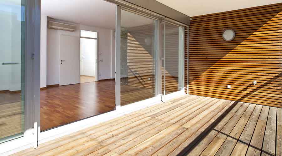 Outdoor wooden terrace and interior floor of a house